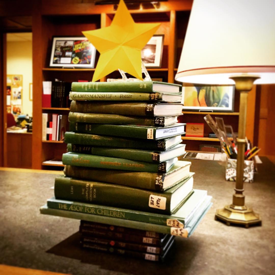 The book tree is back - adorning the front desk to welcome students back for the beginning of Winter Term. #ohrstromlibrary #booktree #greenbooks #star #bookdisplay #library #librariesofinstagram #librarydisplay